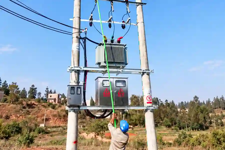 Three-phase oil-immersed transformer with its tank, bushings and mounting base